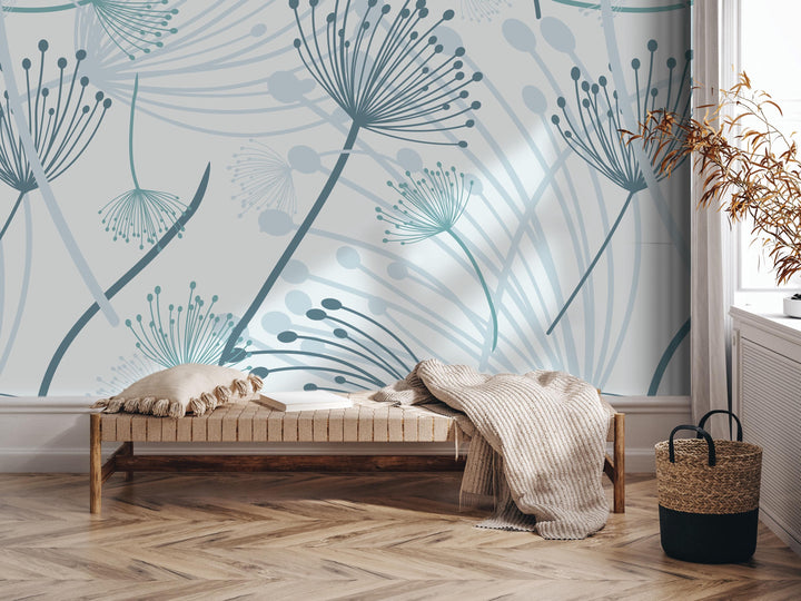 a modern and minimalist interior design with a large wall mural depicting abstract floral patterns in shades of blue and gray. The room includes a wooden bench, a woven basket, and a potted plant, creating a cozy and stylish atmosphere.