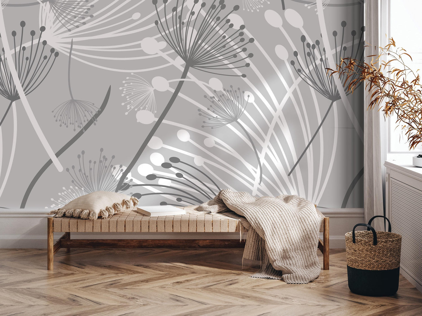 a modern and minimalist interior design with a gray and white floral pattern on the wall behind a wooden bench. The bench is adorned with a throw blanket and a woven basket, adding a touch of coziness to the space. The arrangement of the bench, blanket, and basket creates a visually appealing and inviting atmosphere.