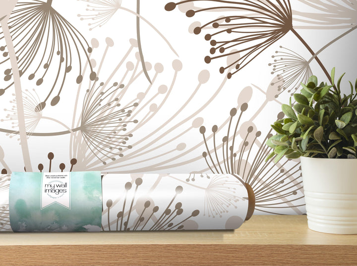 a wall with a floral pattern and a potted plant on a shelf.