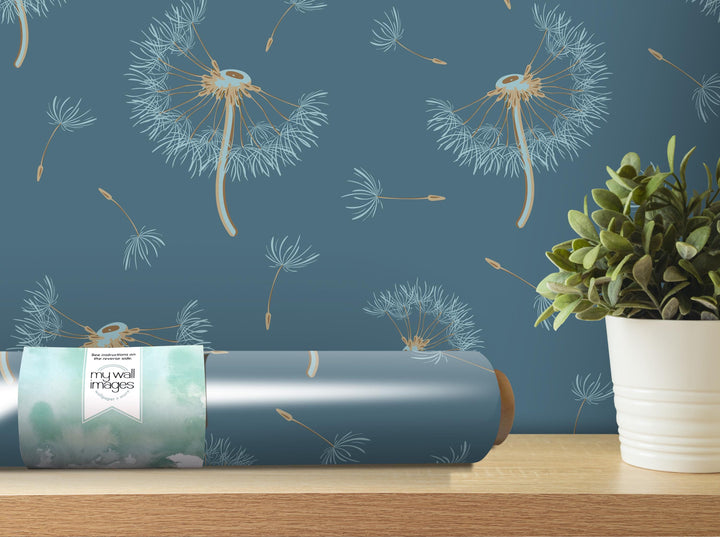 a blue wall with a pattern of dandelions and a potted plant on a shelf.