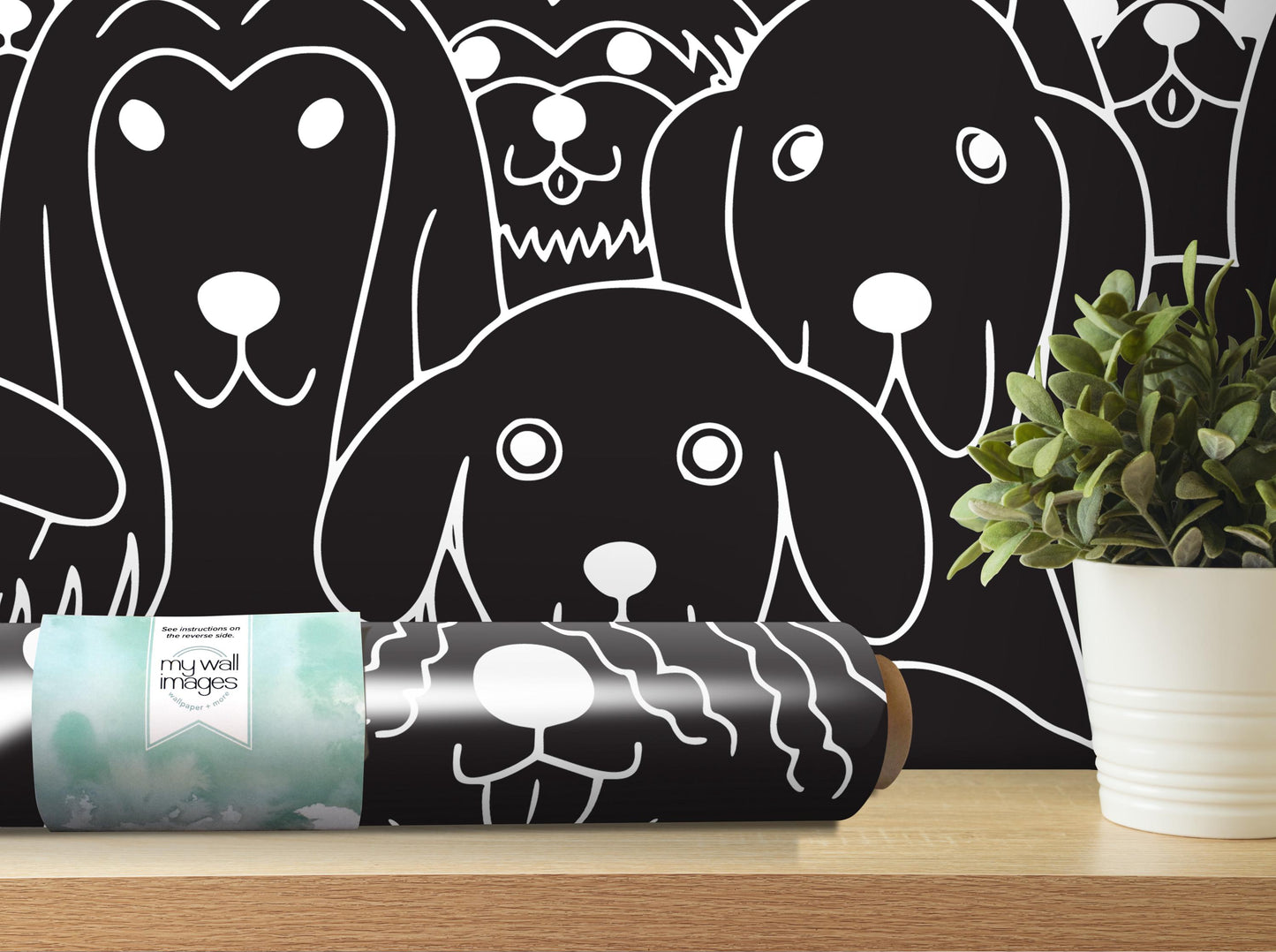 a black and white dog wallpaper with a potted plant and a roll of wallpaper on a shelf.
