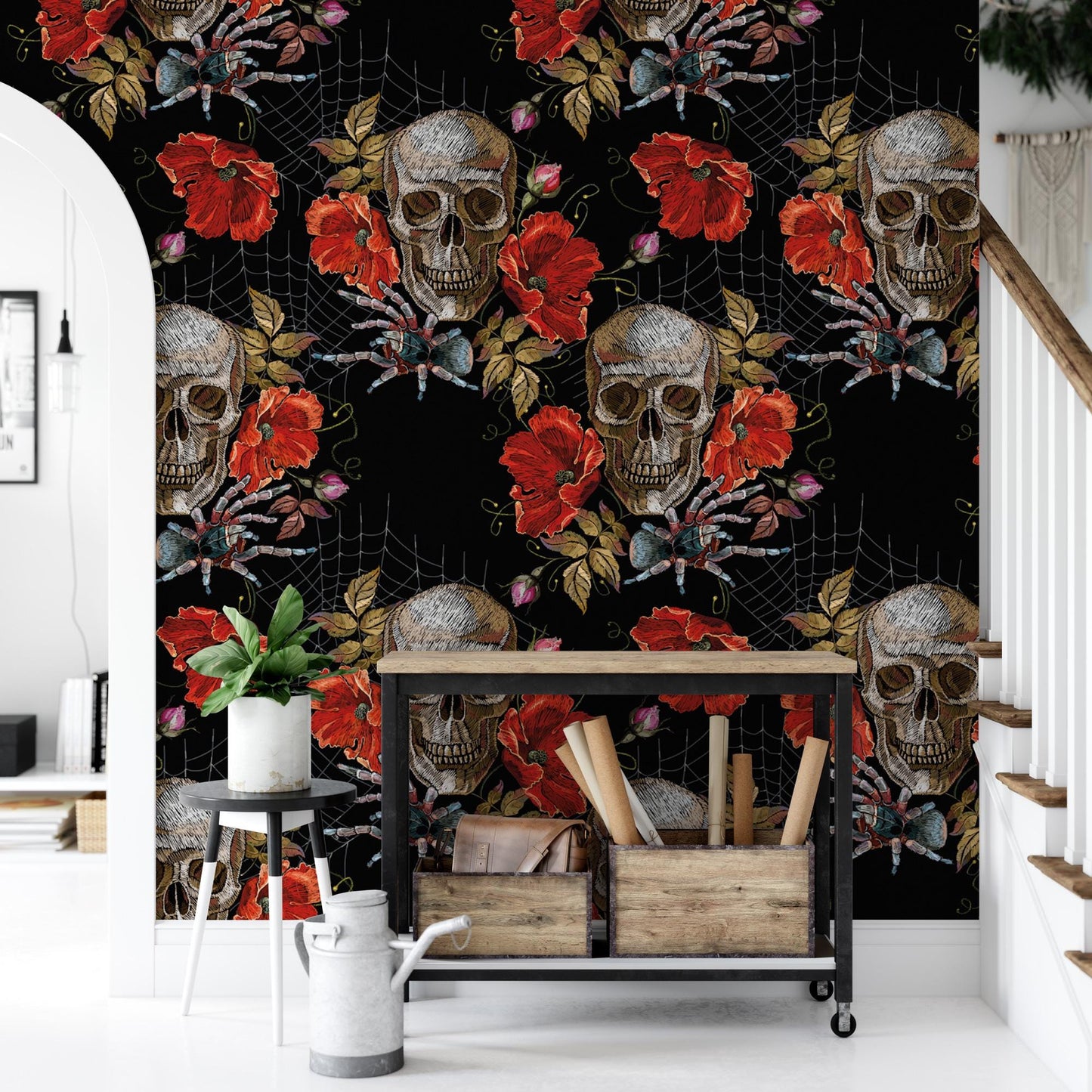 a wallpapered wall with a striking design of red flowers and skull motifs, creating a bold and eye-catching pattern. In the foreground, there is a small table with a plant and some wooden crates, adding a touch of nature and rustic charm to the scene.
