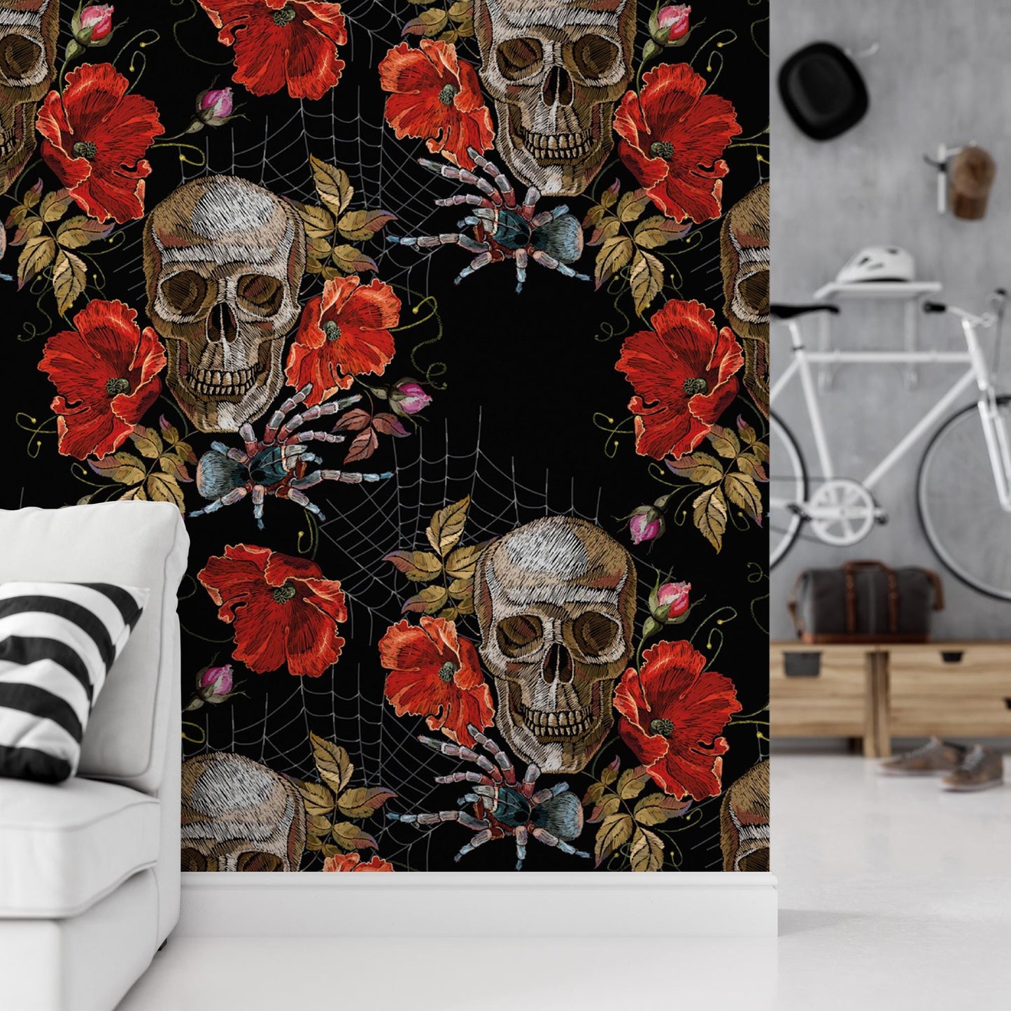 a wall with a repeating pattern of skull and flower designs, including red poppies and a spider, against a black background.