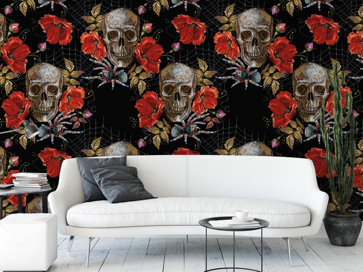 a white sofa with a gray throw pillow, positioned in front of a wall with a black and red floral wallpaper. The wall has a repeating pattern of skull and flower motifs, creating a striking and bold design.
