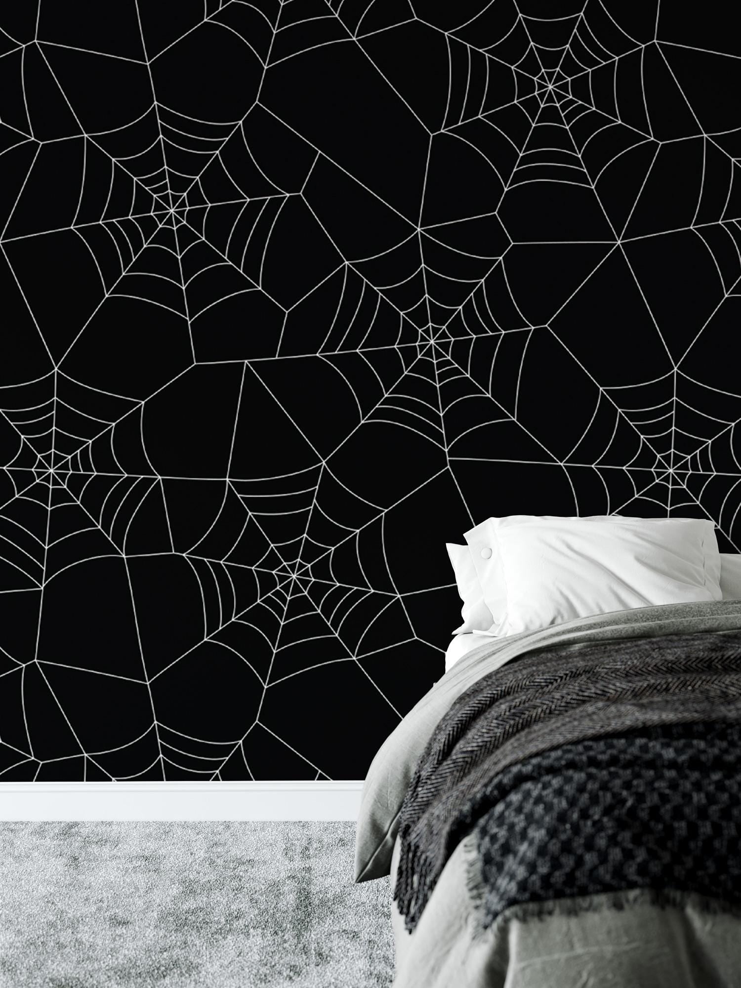 a bedroom with a spider web wallpaper and a bed