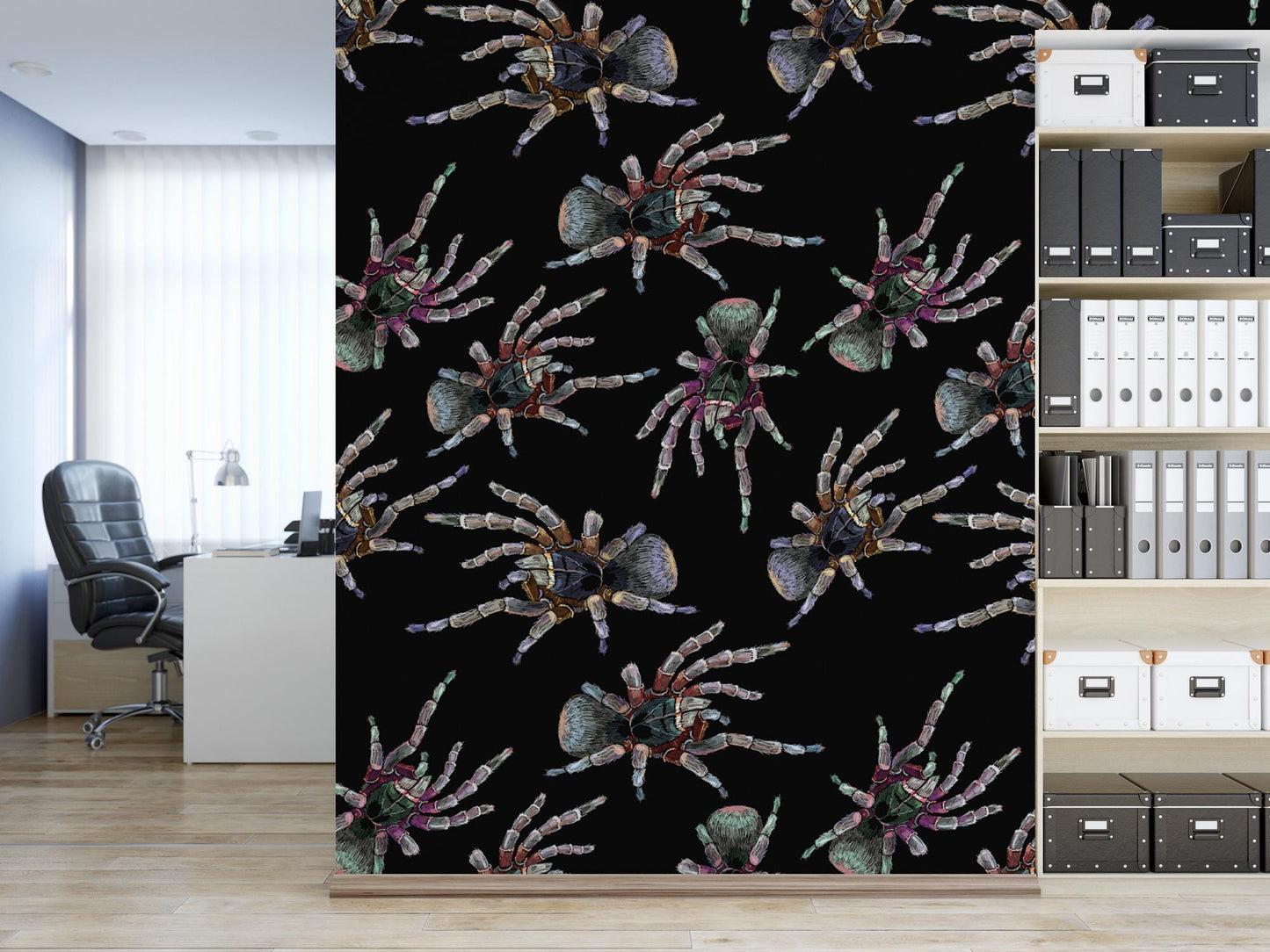a wallpapered wall with a repeating pattern of colorful, detailed illustrations of spiders. The wall is black, and the spiders are depicted in various sizes and positions, creating a visually striking and intricate design. In the background, there is a desk with a chair, suggesting a workspace or office setting.