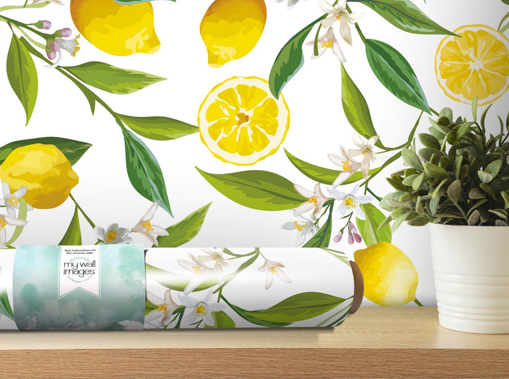 a white vase filled with lemons on top of a wooden table