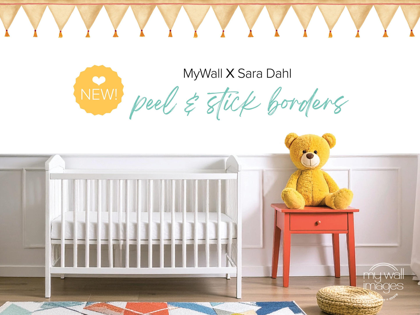 a nursery room with a white crib, a yellow teddy bear, and a red table. The crib is positioned against a white wall, and the teddy bear is sitting on the table. The room has a colorful rug on the floor, and there are decorative elements such as a banner and a tassel hanging above the crib.