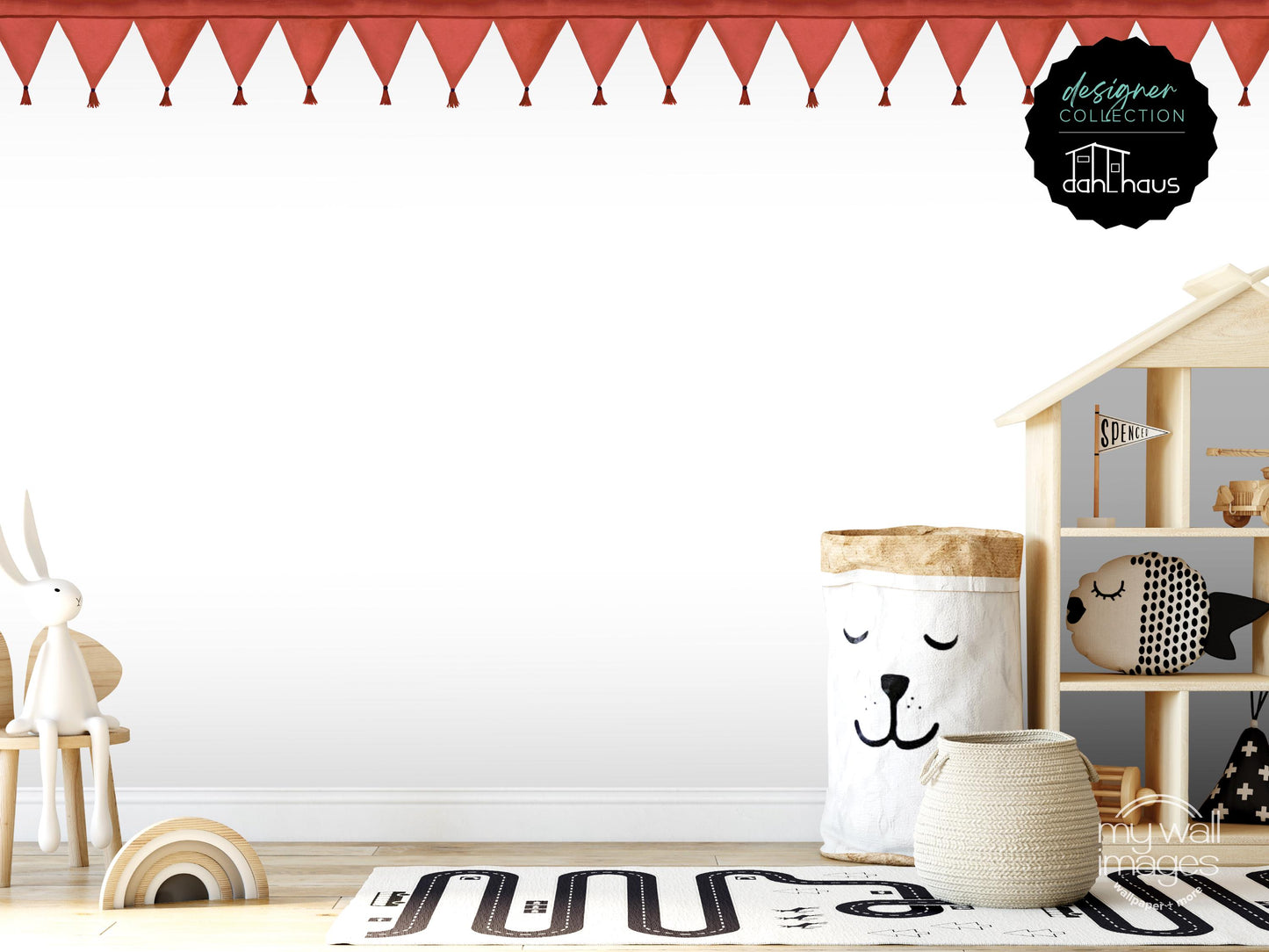A child's bedroom with a white wall, a wooden shelf with a toy house, and various toys and decorative items.