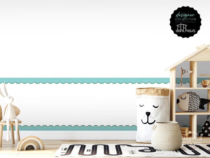 A child's bedroom with a wooden shelf, a toy rabbit, a toy fish, and a toy car. The room has a white and teal color scheme, and there is a large white bag with a face on it.