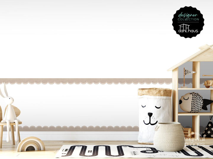 A minimalist and modern nursery room with a wooden shelf, a toy car, and a basket with a face on it. The room has a clean and simple design, with a white wall and a scalloped edge along the bottom.