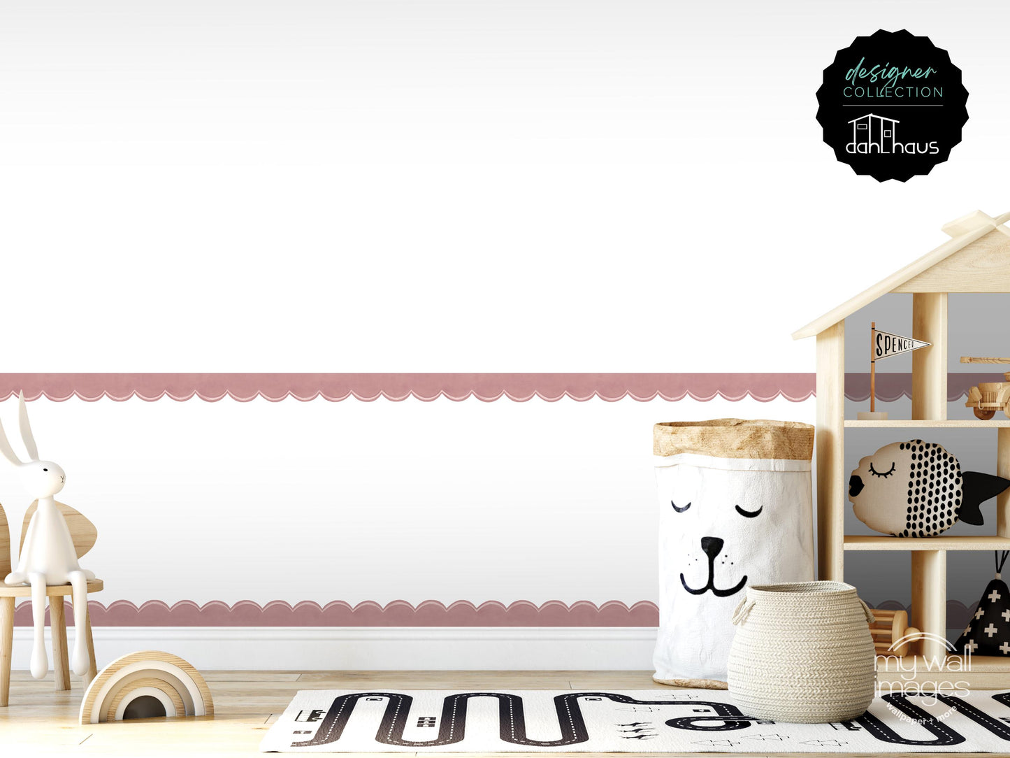 A child's bedroom with a pink scalloped border, a wooden dollhouse, and various toys, including a stuffed animal and a basket with a face.