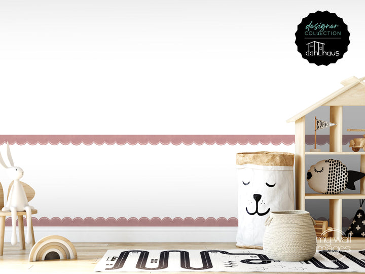 A child's bedroom with a pink scalloped border, a wooden dollhouse, and various toys, including a stuffed animal and a basket with a face.