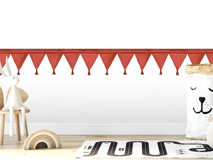 A white rabbit sits on a wooden chair in a room with a red banner hanging above.