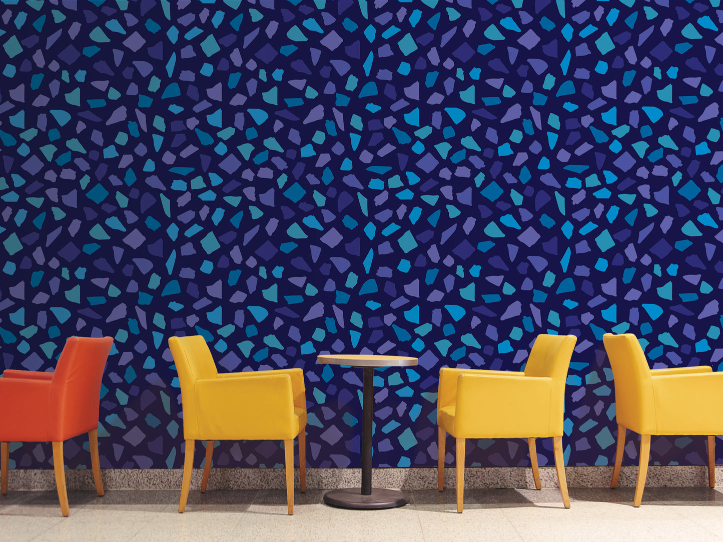 a vibrant and colorful mosaic wall with a table and four yellow chairs arranged in front of it.