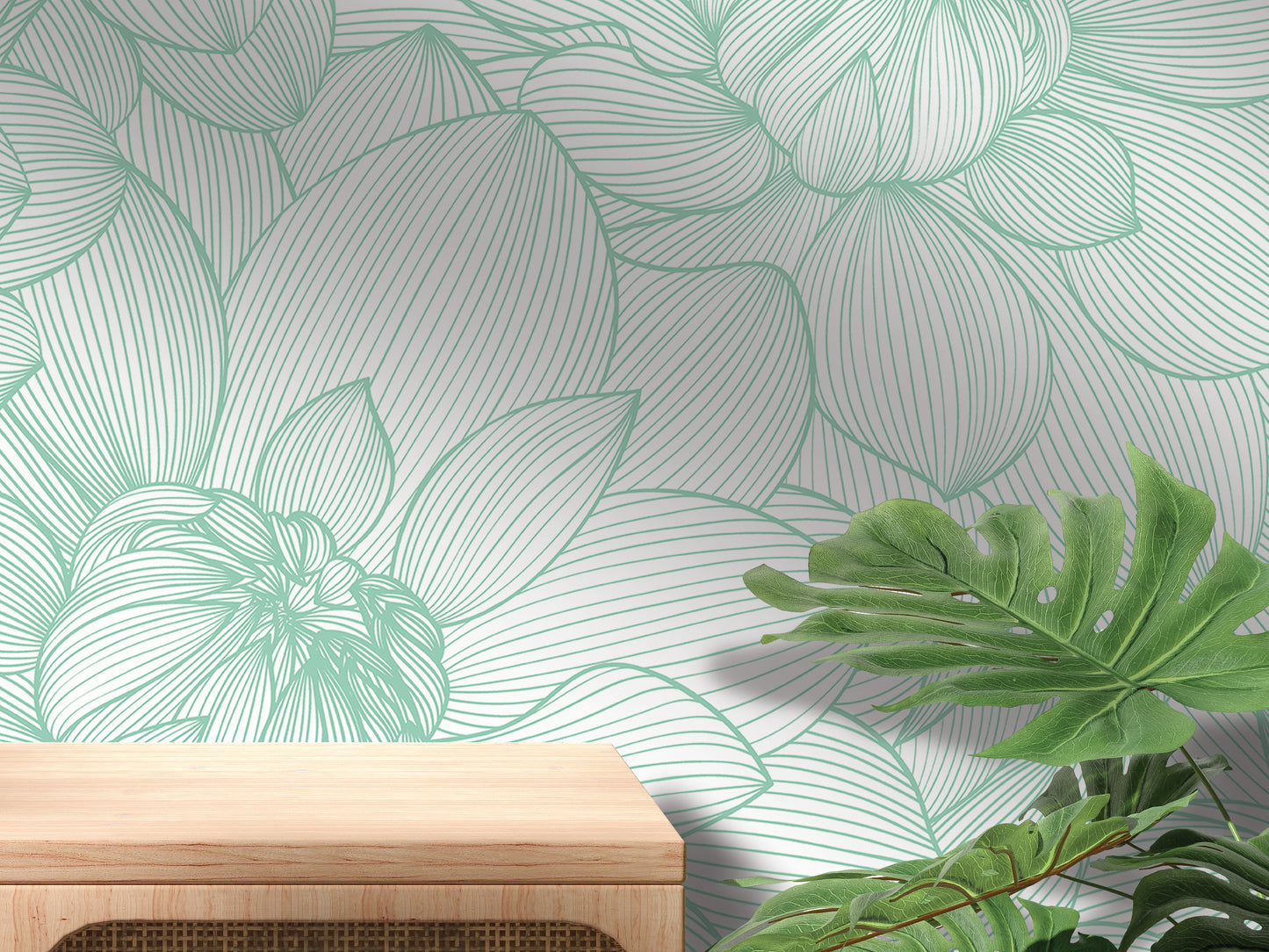a wallpapered wall with a wooden table in the foreground, and a plant with large leaves in the background.