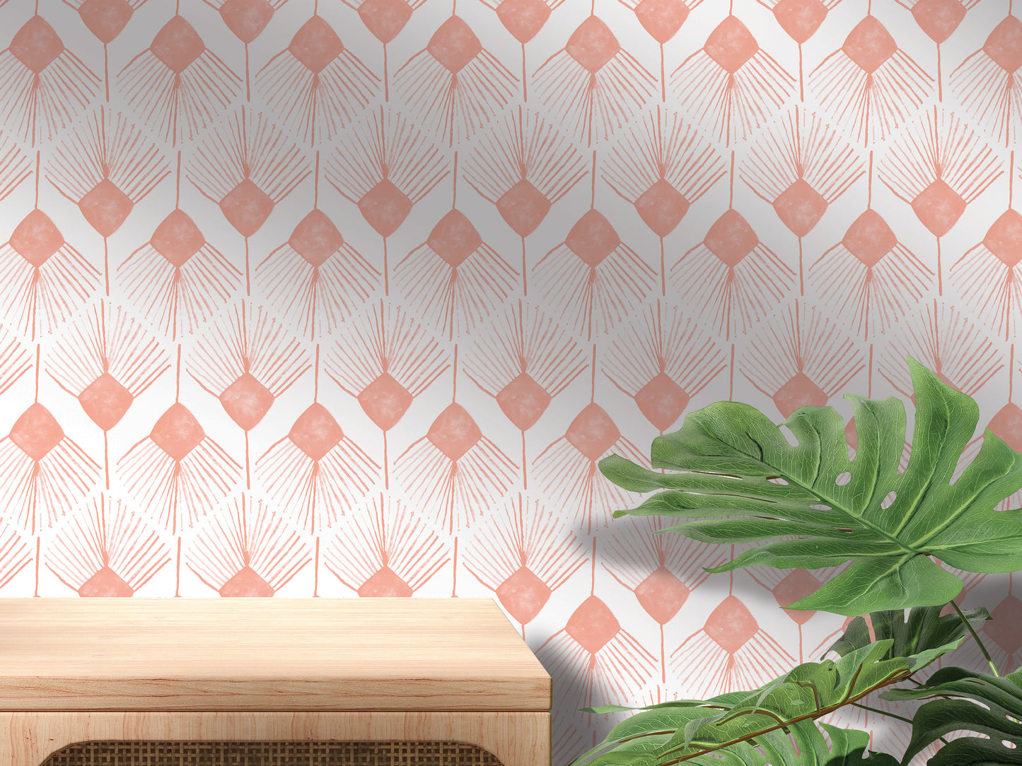 a wooden table and a large green plant against a wall with a repeating pattern of pink and white diamond shapes.