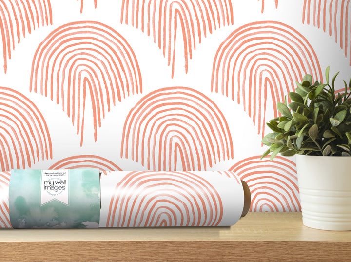 a wall with a repeating pattern of orange and white arches, and there is a potted plant placed on a wooden shelf next to the wall.