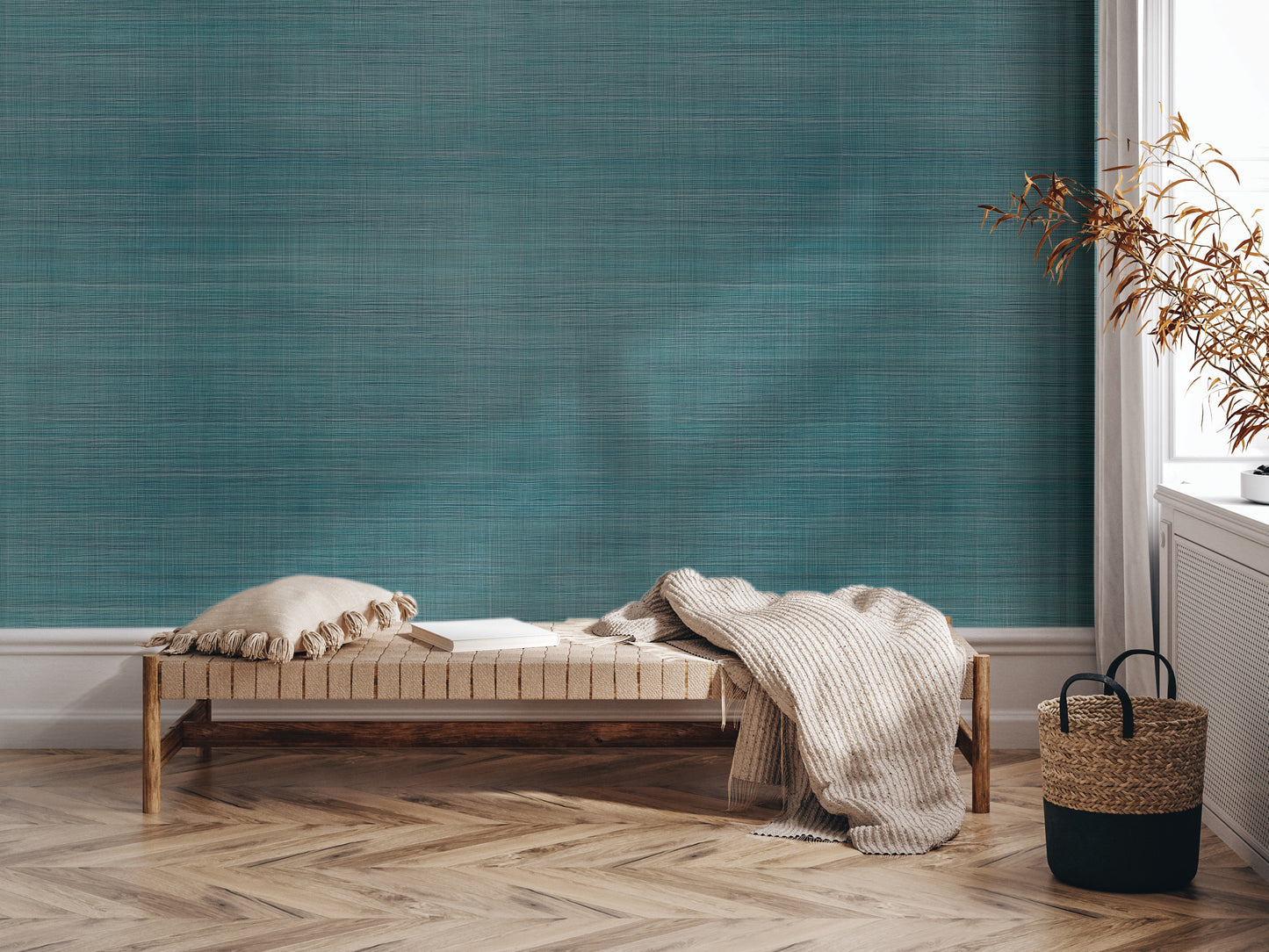 a cozy corner with a wooden bench, a woven basket, and a stack of books, all set against a textured blue wall.