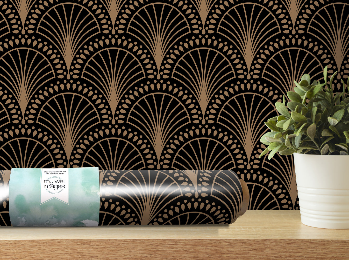 a decorative wall with a repeating pattern of black and gold fan-like designs, and a potted plant placed on a shelf next to the wall.