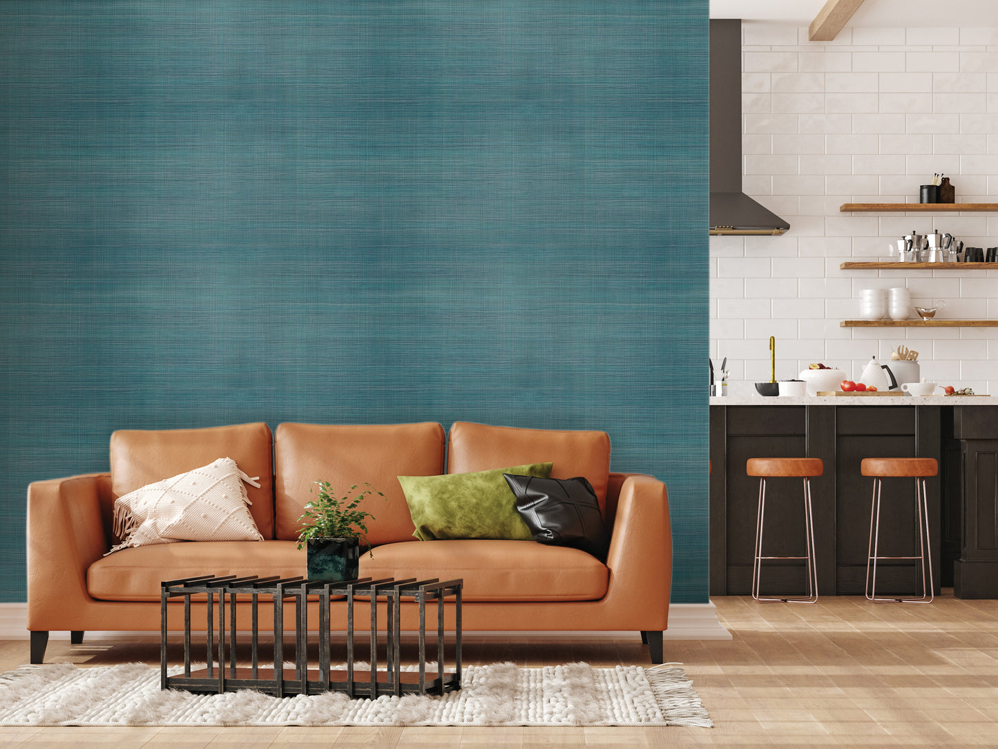 a modern living room with a large teal-colored textured wall, a brown leather sofa with orange throw pillows, a black metal coffee table, and a kitchen counter with bar stools.