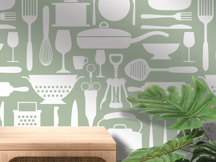 a green kitchen wall with utensils and cooking utensils