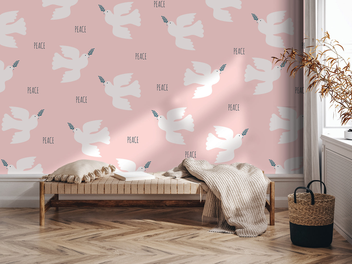 a pink wall with a repeating pattern of white doves and the word "Peace" written on it. In the foreground, there is a wooden bench with a blanket draped over it, and a woven basket next to it.