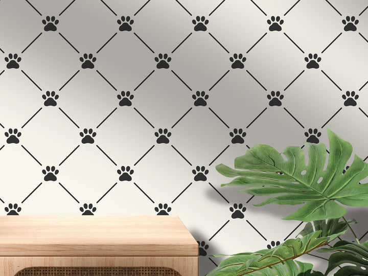 a wall with a repeating pattern of black paw prints and a wooden table in the foreground.