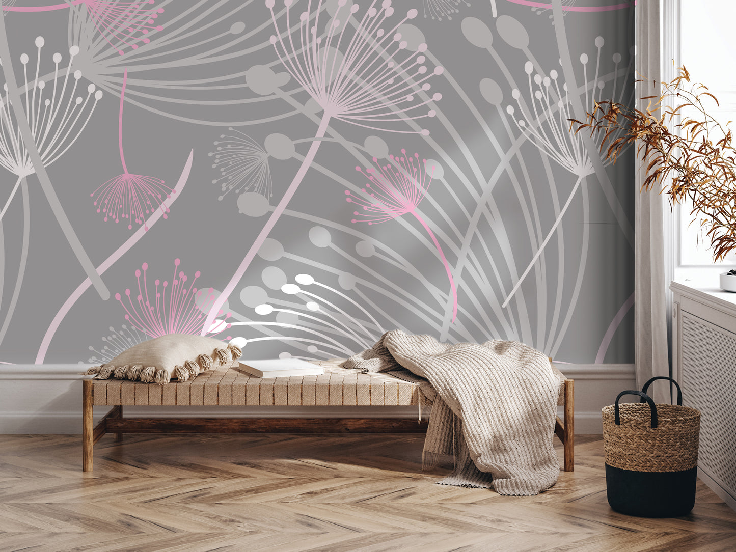 a modern and minimalist interior design with a gray and white color scheme. The focal point is a large wall mural with a floral pattern in shades of pink and white. In the foreground, there is a wooden bench with a blanket draped over it, and a woven basket next to it. The overall layout and decor create a clean and visually appealing space.