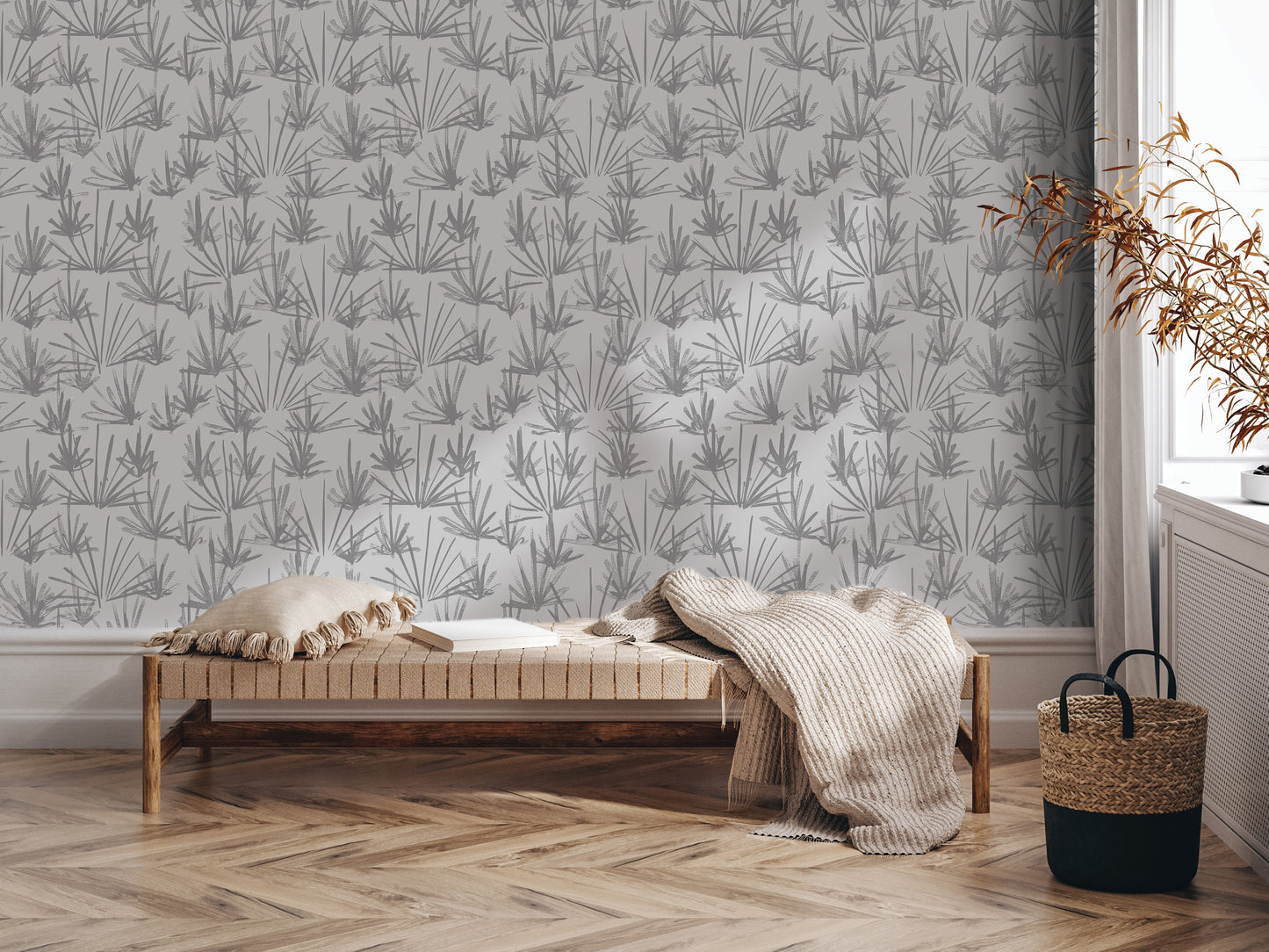 a modern living room with a wooden floor and a patterned wallpaper. In the center of the room, there is a wooden bench with a beige pillow on it. To the right of the bench, there is a woven basket. A plant is also present in the room, adding a touch of greenery to the space.