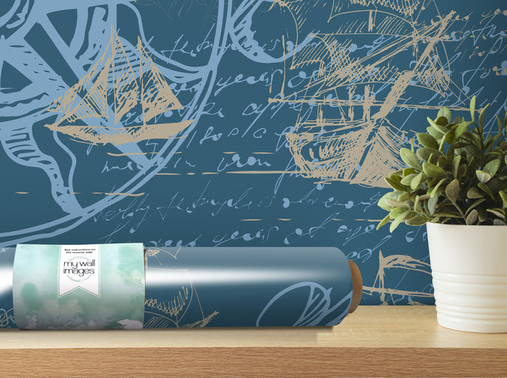 a blue wall with a large, intricate pattern of ships and boats, along with a potted plant and a roll of wallpaper on a shelf.