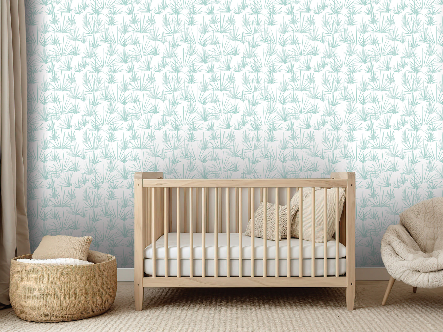 a nursery room with a wooden crib, a woven basket, and a beige chair. The crib is positioned in front of a wall with a repeating pattern of green and white leaves.