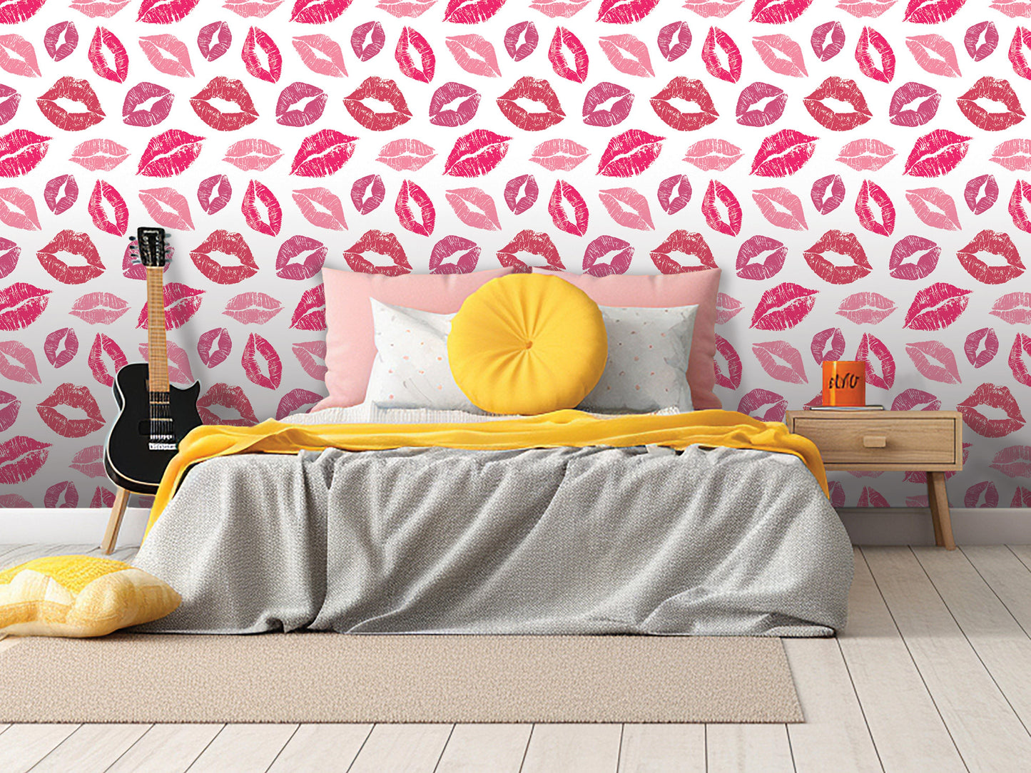 a bedroom with a bed, yellow pillow, and a guitar. The walls are covered in a pink and white patterned wallpaper with pink and white lips.