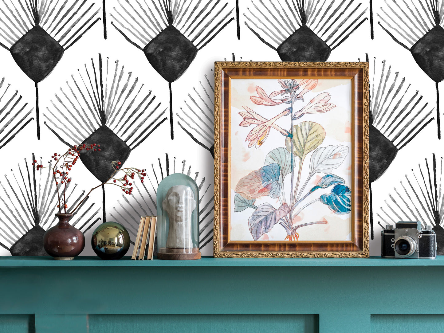 a shelf with various decorative items, including a framed drawing of a plant, a vase with flowers, a glass dome, and a camera. The shelf has a teal color and is set against a black and white patterned wall.