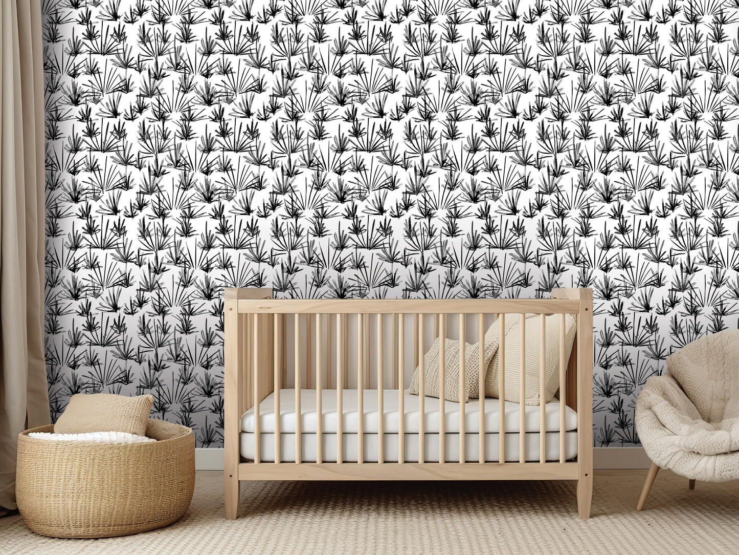 a nursery room with a wooden crib, a woven basket, and a beige chair. The room has a black and white patterned wallpaper with a repeating design of black and white flowers or leaves.