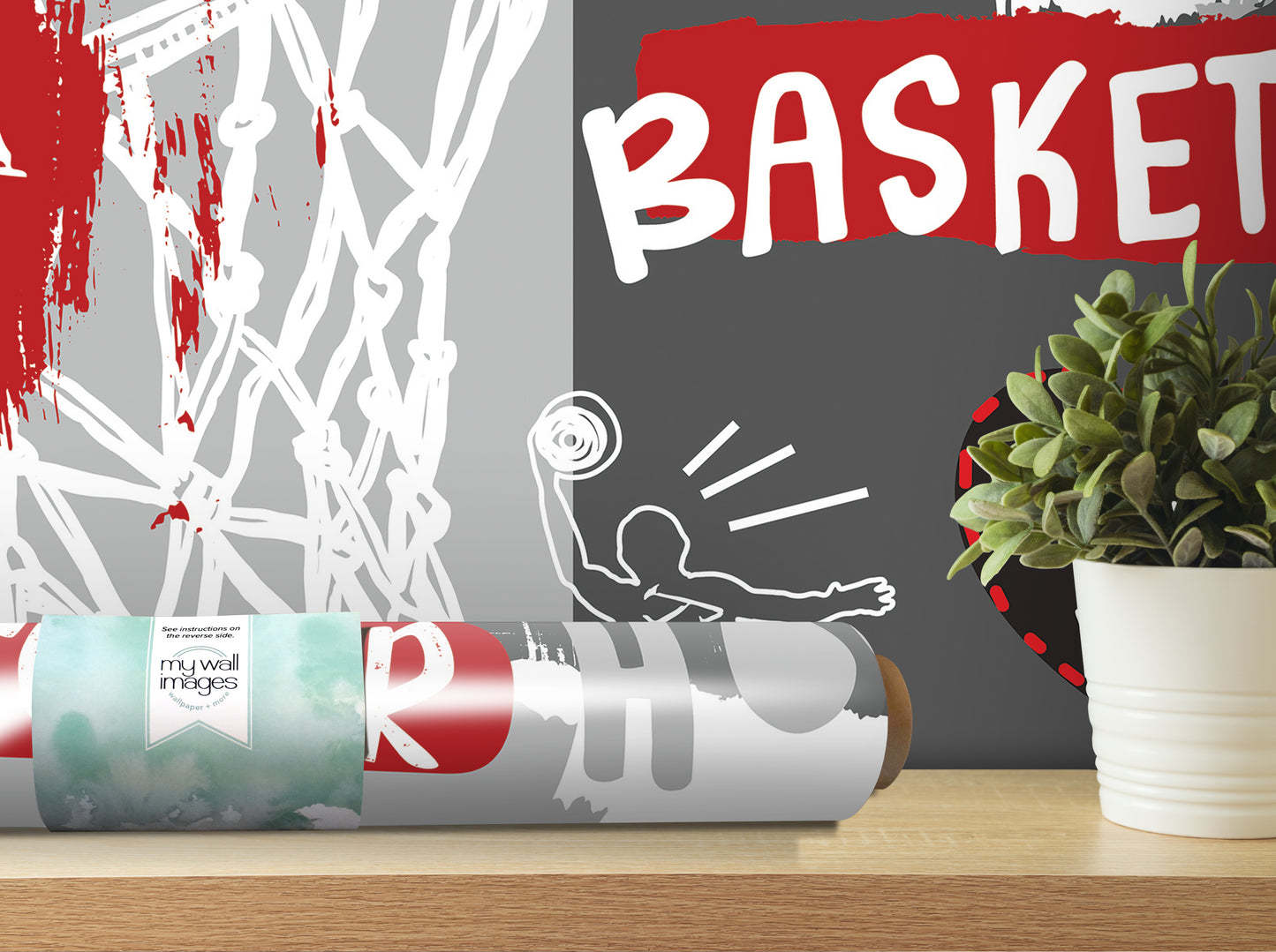 a basketball-themed poster with the word "BASKET" prominently displayed, along with a potted plant and a roll of wallpaper.