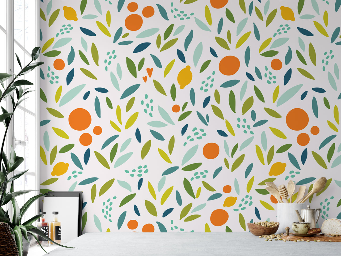 a vibrant and colorful wallpapered wall with a repeating pattern of orange and green leaves, along with other abstract shapes and designs. In the foreground, there is a table with various items on it, including a bowl, a cup, and a spoon. A potted plant is also visible in the background, adding a touch of greenery to the scene.