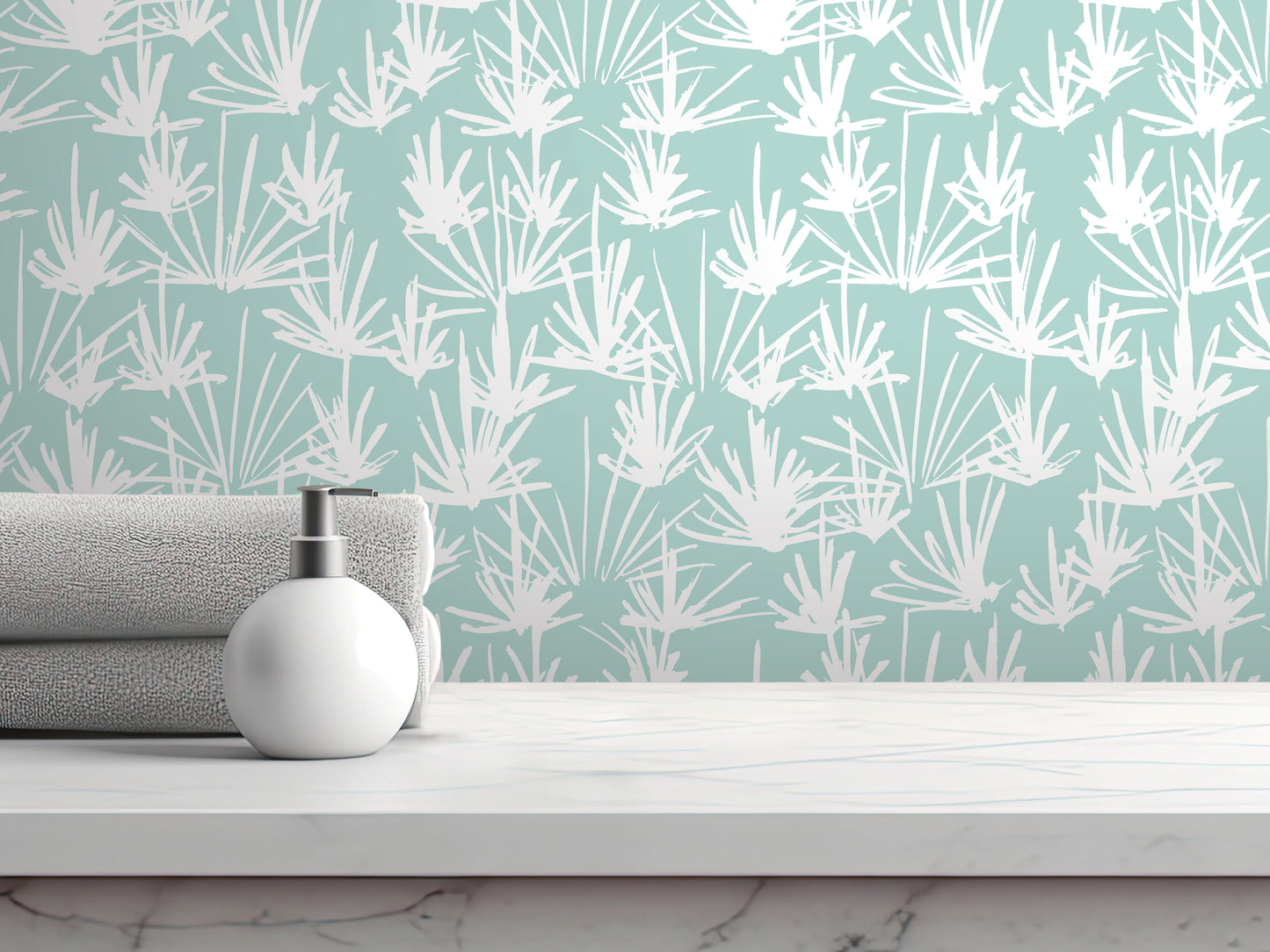 a white pump soap bottle on a white countertop, with a rolled-up gray towel underneath it. The backdrop is a wall with a repeating pattern of white and green leaves or flowers.