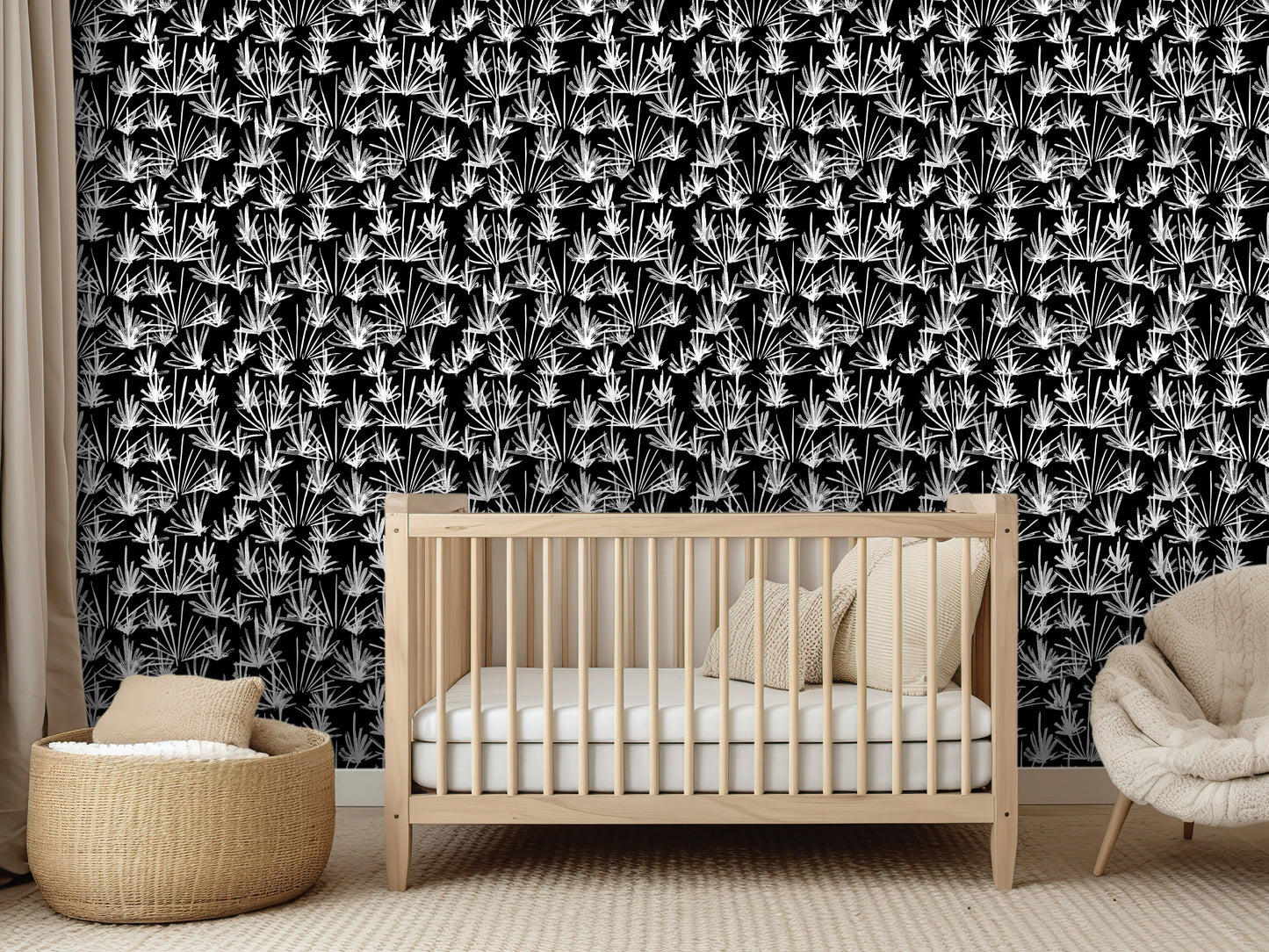 a nursery room with a wooden crib, a beige chair, and a woven basket. The room has a black and white patterned wallpaper with a repeating design of white flowers or leaves.