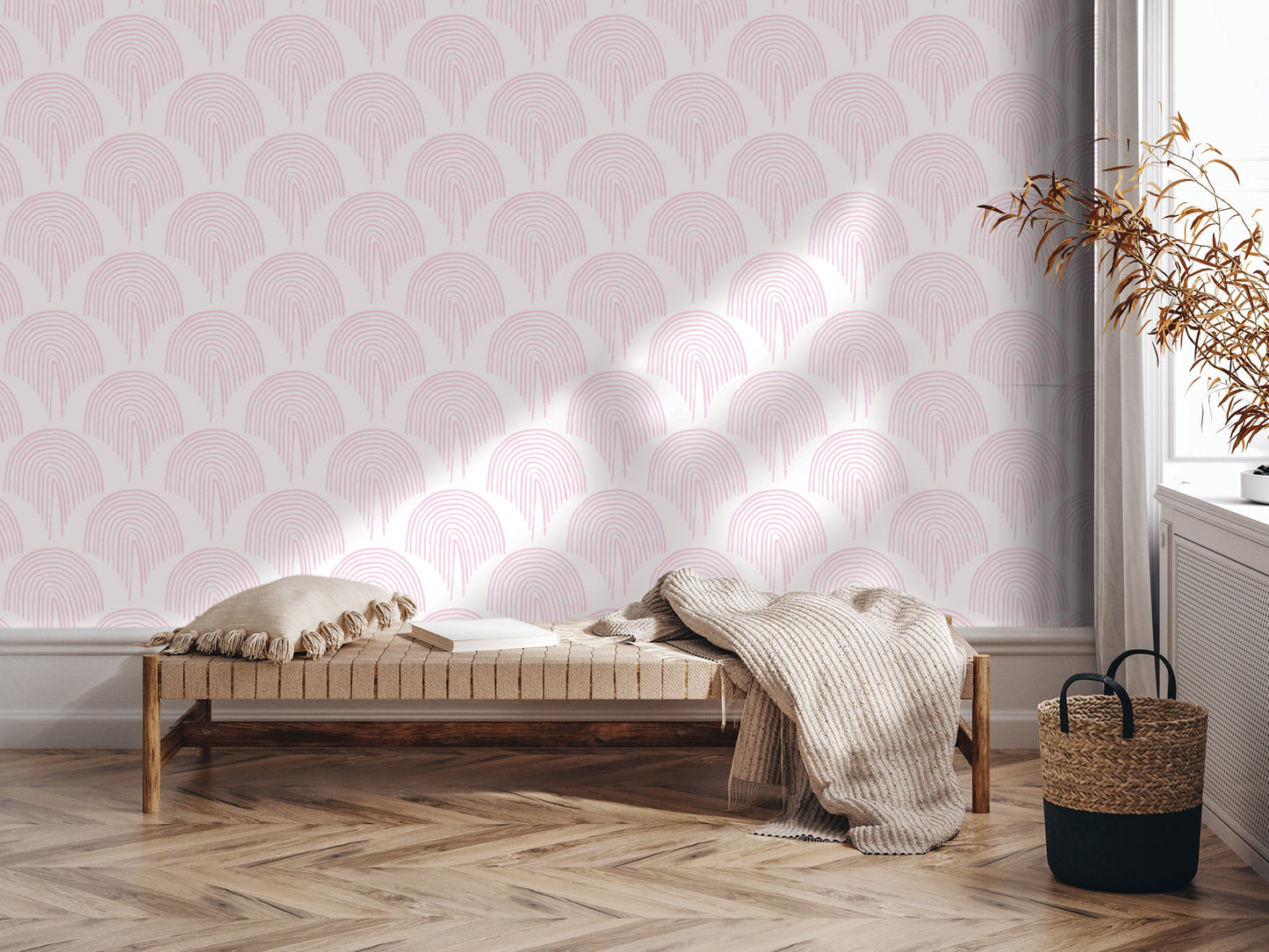 a cozy and inviting living space with a bench, a woven basket, and a decorative plant. The bench is positioned against a wall with a repeating pattern of pink and white circles, creating a visually appealing and harmonious atmosphere.