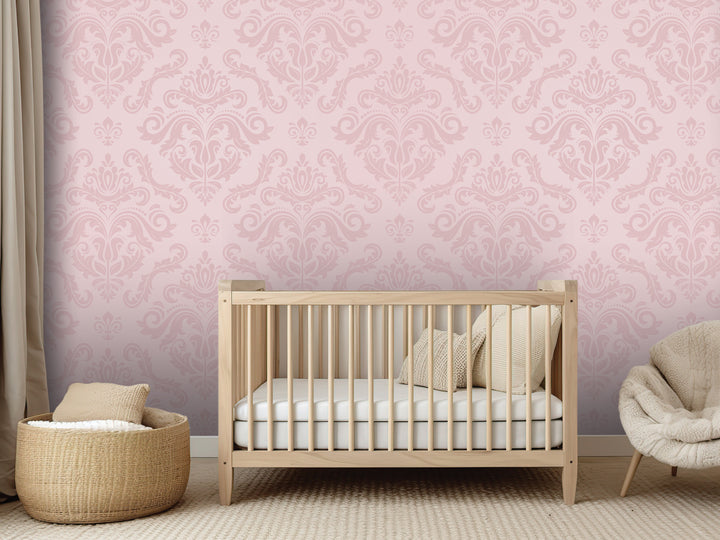 a nursery room with a wooden crib, a woven basket, and a plush chair. The room has a pink and white color scheme with a decorative wall pattern.