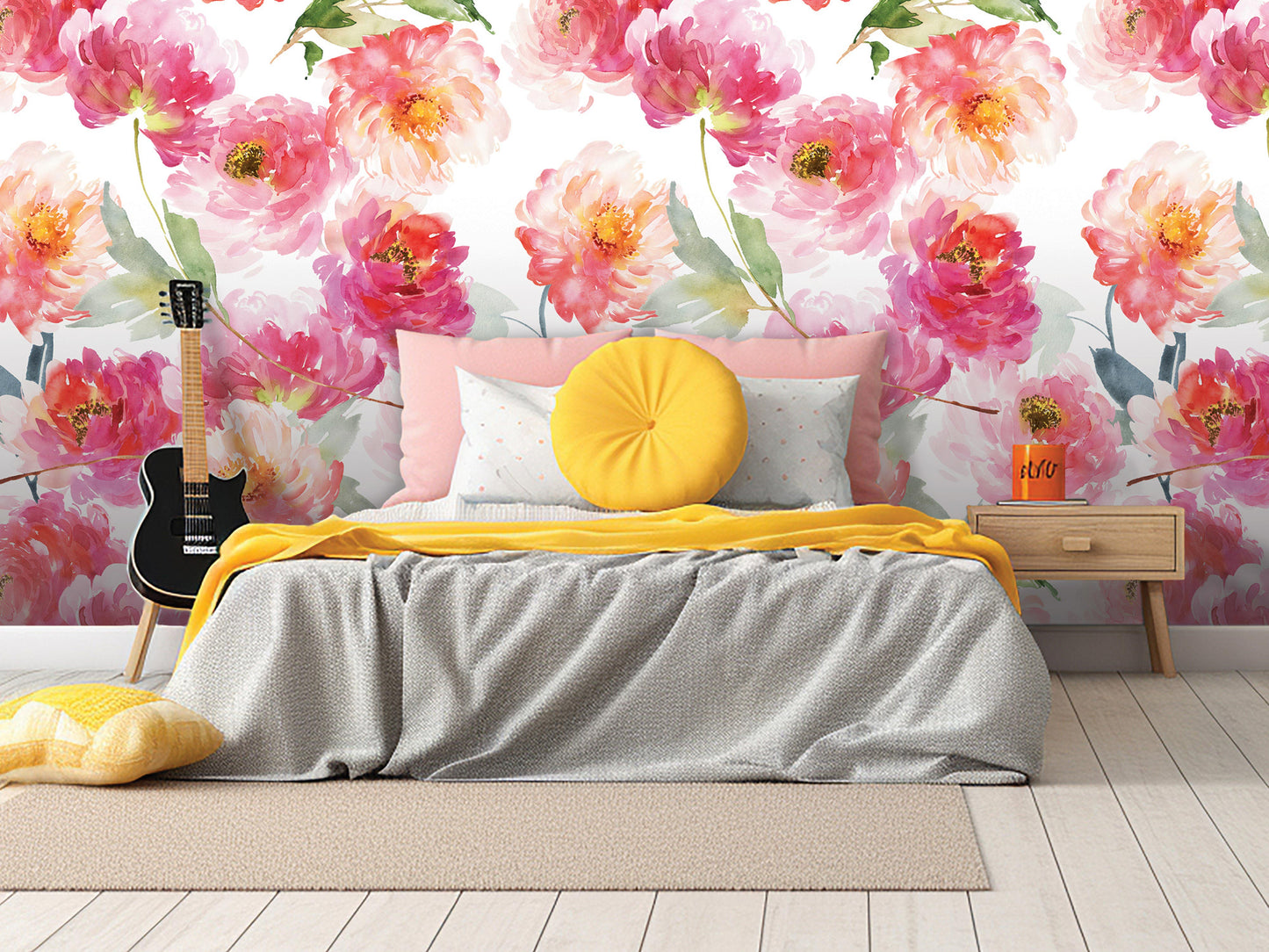 a bedroom with a bed, yellow pillows, and a guitar. The wall behind the bed has a floral wallpaper with pink and orange flowers.