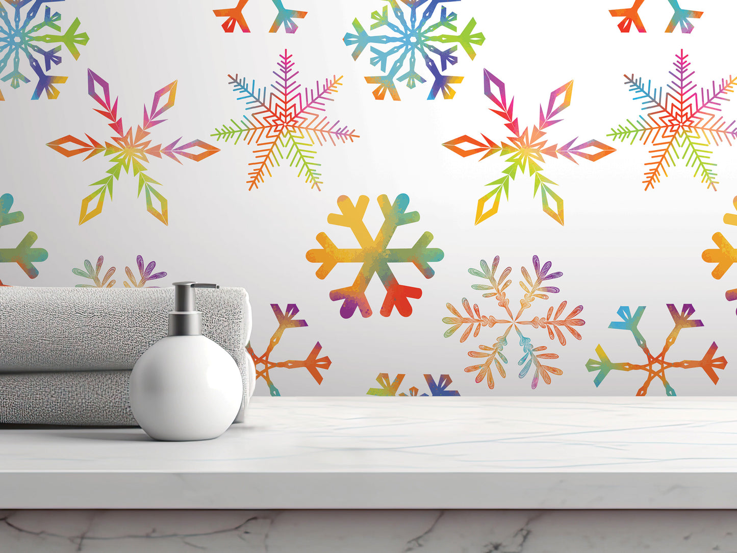 a white shelf with a white soap dispenser and a gray towel, set against a wall with a vibrant, colorful snowflake pattern.