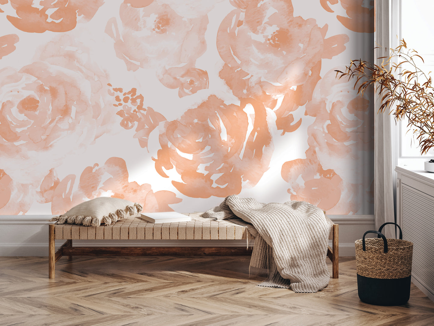 a cozy and inviting living space with a wooden floor and a bench. The bench is adorned with a throw blanket and a pillow, creating a comfortable seating area. The wall behind the bench is decorated with a floral pattern in shades of peach and white, adding a touch of warmth and elegance to the room. A woven basket is placed next to the bench, and a potted plant is situated nearby, further enhancing the room's ambiance.