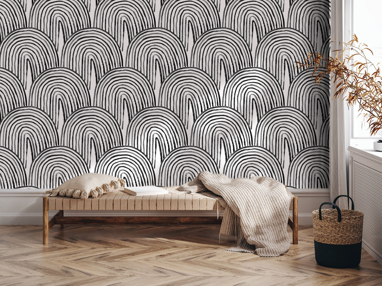 a modern interior design with a black and white geometric pattern on the wall behind a wooden bench. The bench is placed on a hardwood floor, and there is a woven basket nearby.