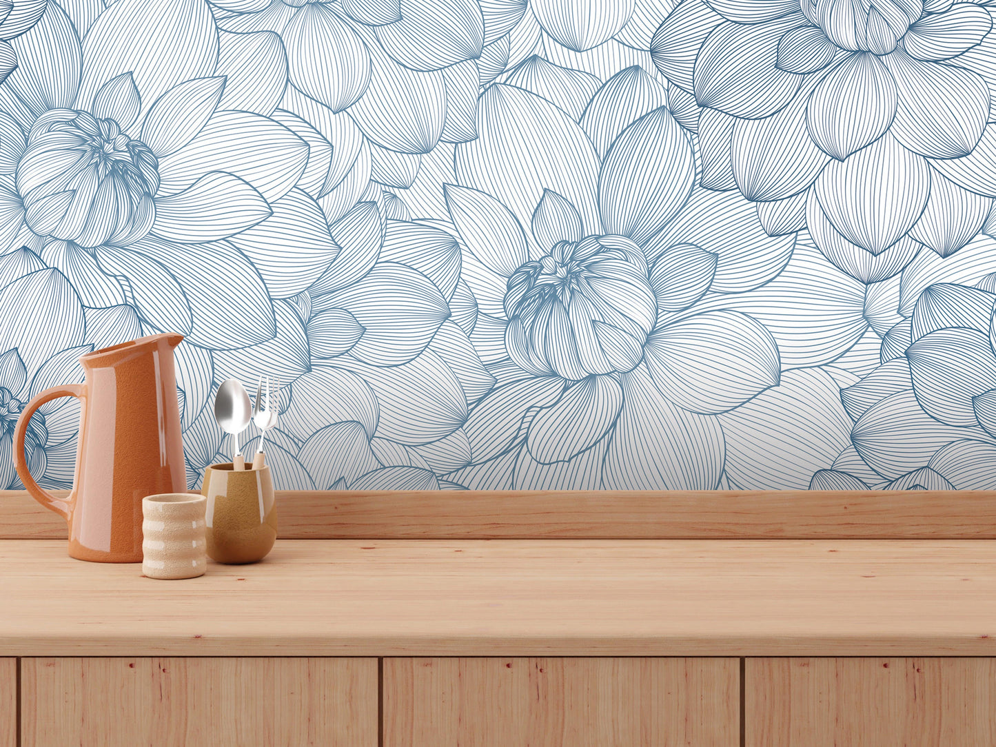 a wooden table with various items on it, including a pitcher, a small vase, and a spoon. The table is set against a wall with a blue and white floral pattern.