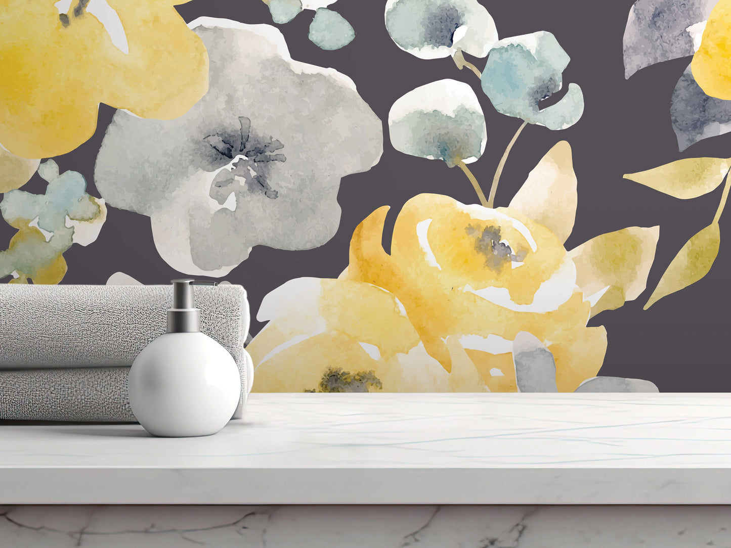 a white soap dispenser on a white marble countertop, with a gray towel and a yellow and white floral wallpaper in the background.
