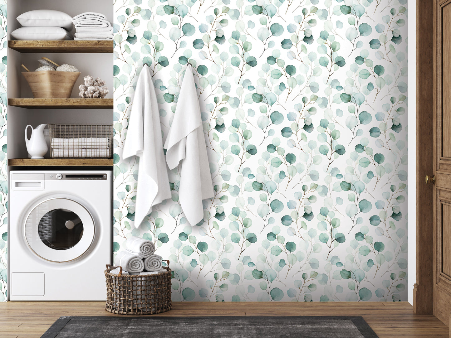 a bathroom with a white washing machine, a wooden shelf with towels and baskets, and a wallpapered wall with a green leaf pattern.