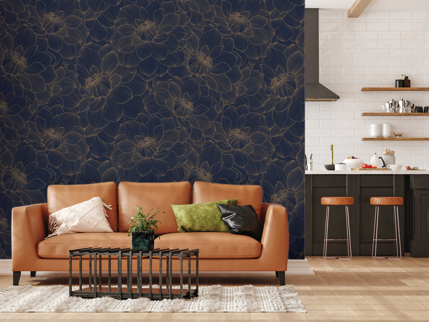 a modern living room with a large floral wallpaper on the wall behind a brown leather sofa. The sofa is accompanied by a black coffee table and a green throw pillow. In the background, there is a kitchen area with a countertop and a shelf holding various kitchen items.