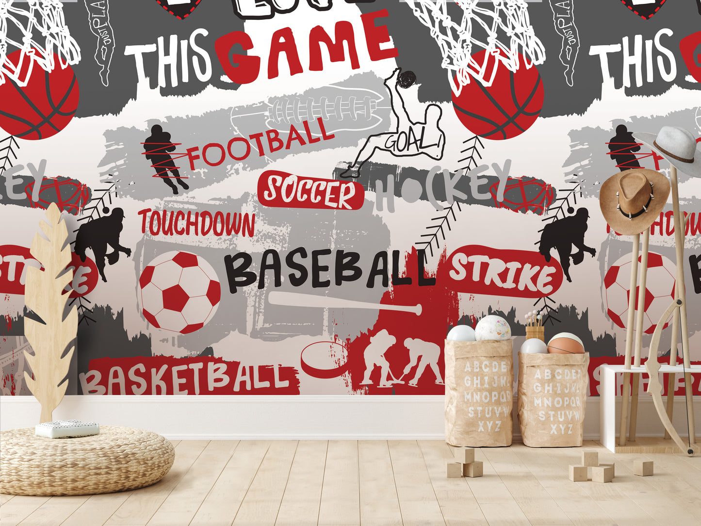 a wall with a collage of various sports-related images, including basketball, soccer, and baseball, along with the words "FOOTBALL", "SOCcer", "HOCKEY", "TOUCHDOWN", "BASEBALL", "STRIKE", and "BASKETBALL". There are also some wooden objects, such as a hat rack and a basket, placed in front of the wall.